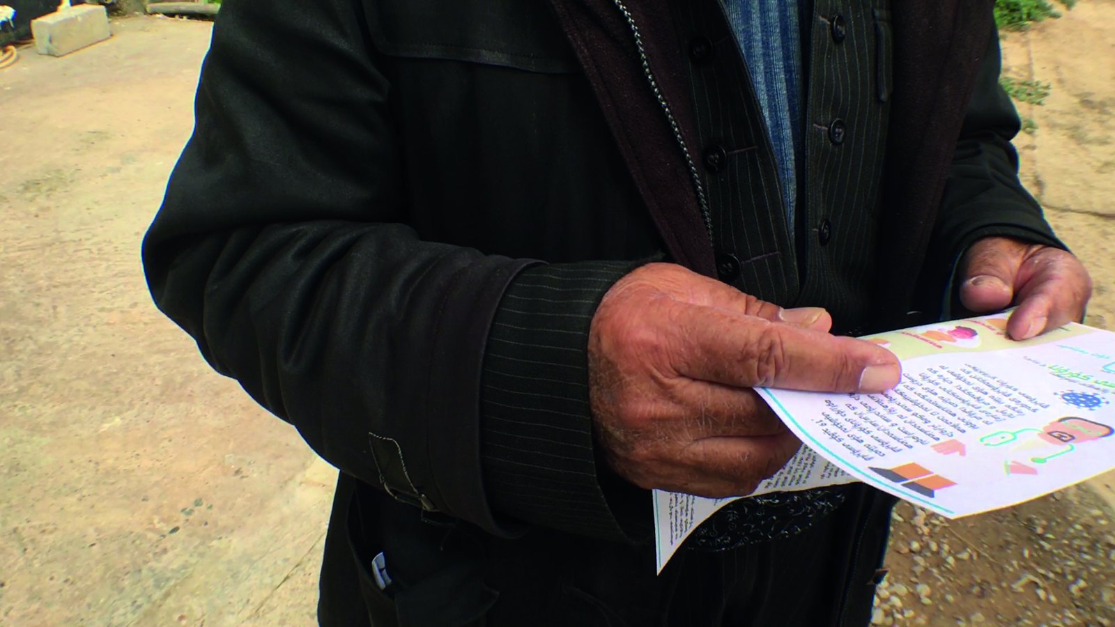 A man reads a health awareness brochure