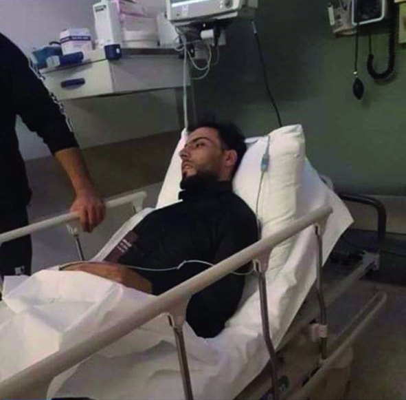 A young patient rests in a hospital bed during treatment
