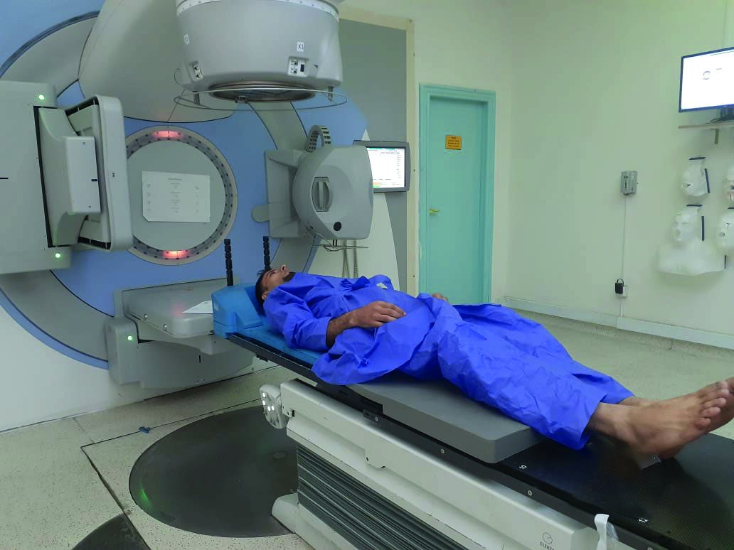 A patient receives radiation therapy in a hospital