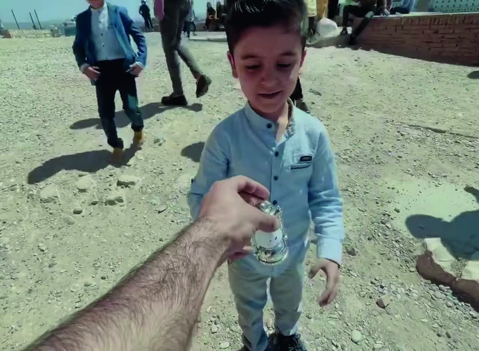 A child lights up while holding a Ramadan gift from our caravan in Erbil